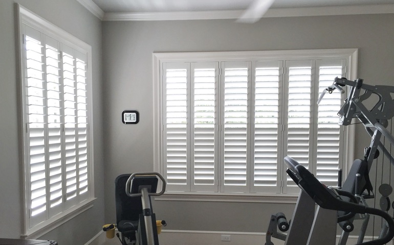 Minneapolis home gym with shuttered windows.